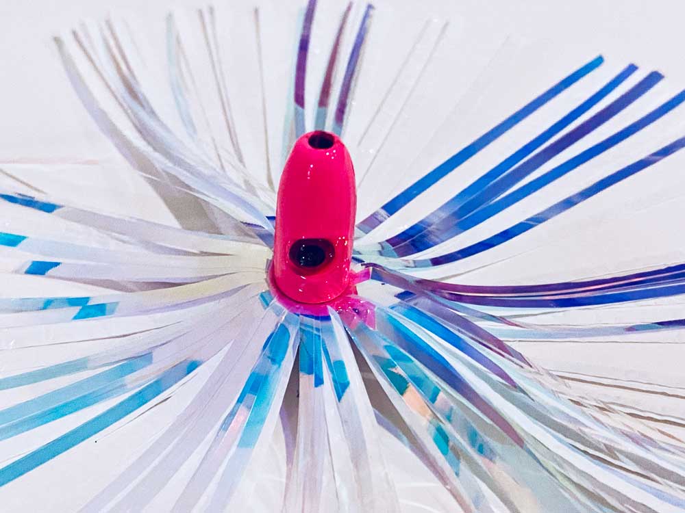 Mylar Duster Lure 4.5" Silver Holographic White Crinkle - close up of 1oz hot pink lead head with black eye