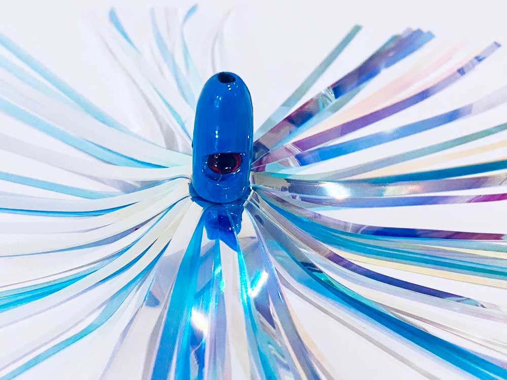 Mylar Duster Lure 4.5" Cotton Candy Blue White - close up of 1oz light blue lead head with red eye