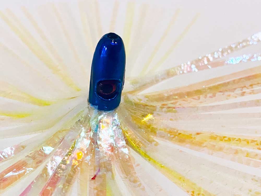 Mylar Duster Lure 4.5" Chartreuse Pearl Crinkle - close up of 1oz cobalt blue lead head with red eye