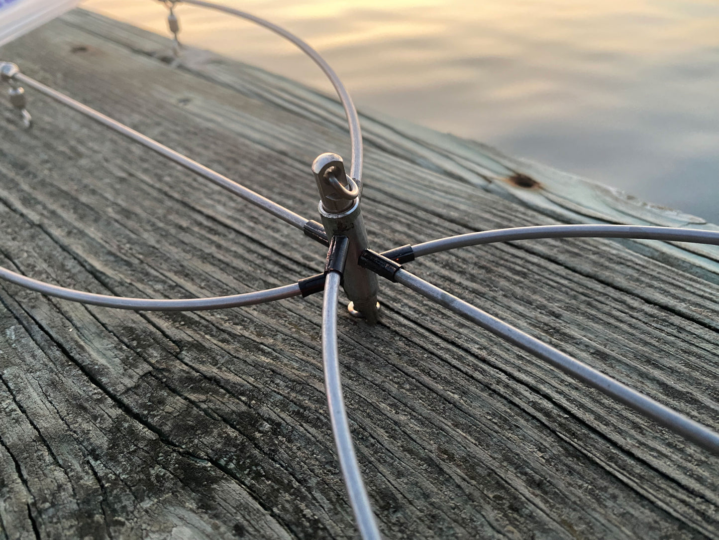 36 inch stainless steel dredge bar hardware detail - center connector at sunset