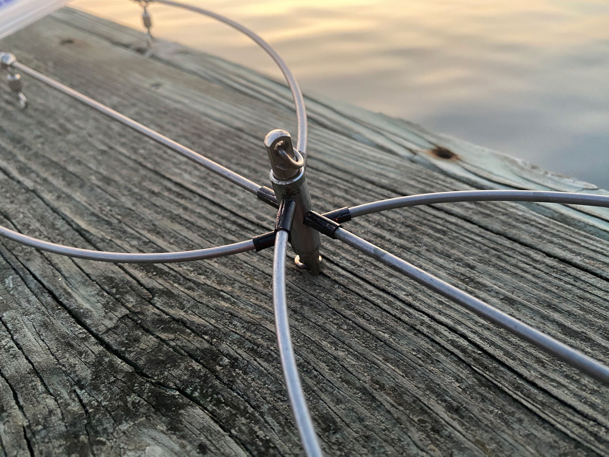36 inch stainless steel dredge bar hardware detail - center connector at sunset