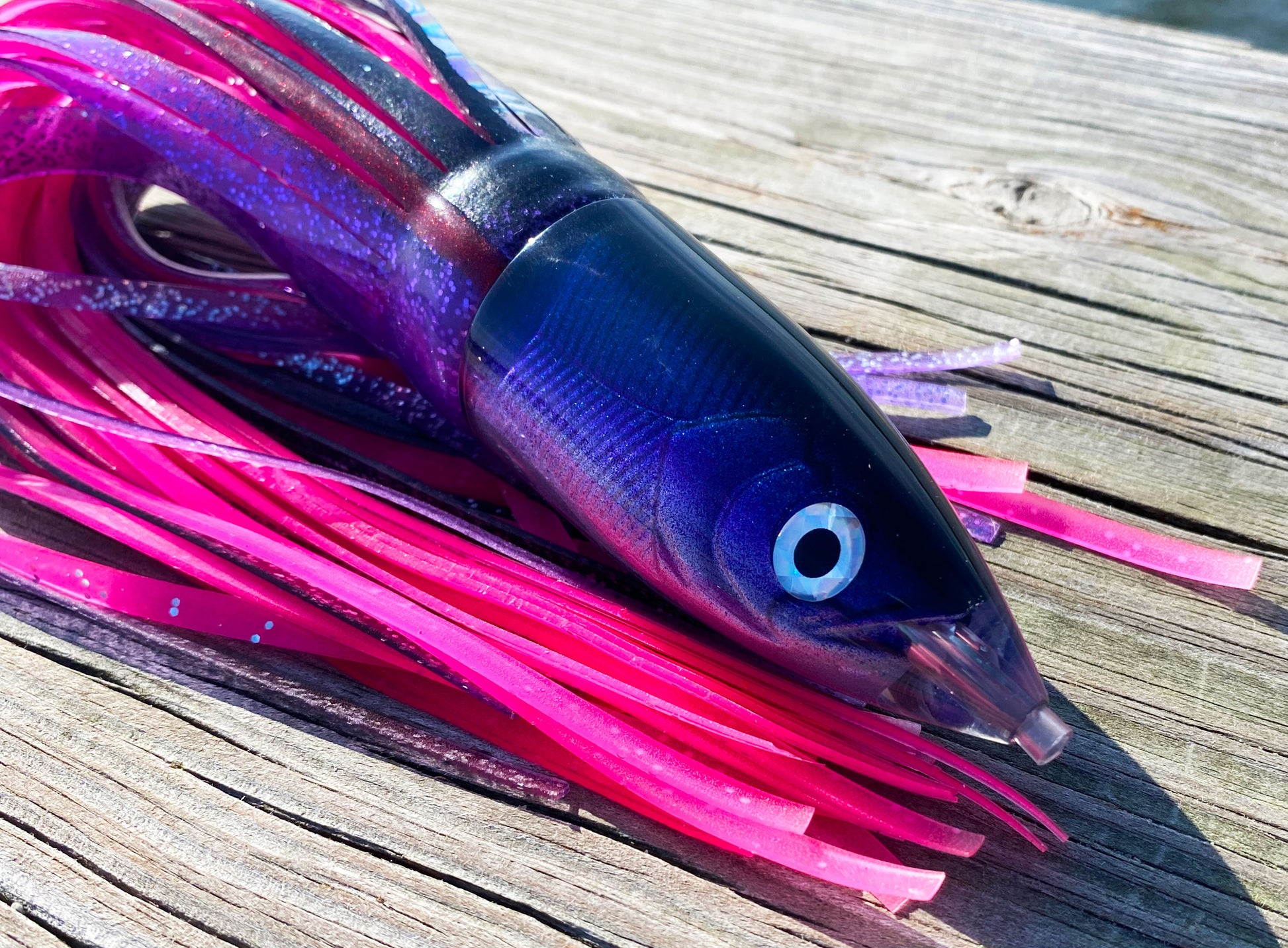Moon Tide Dart Magic close-up of purple/blue/silver smooth bullet head with reflective eye